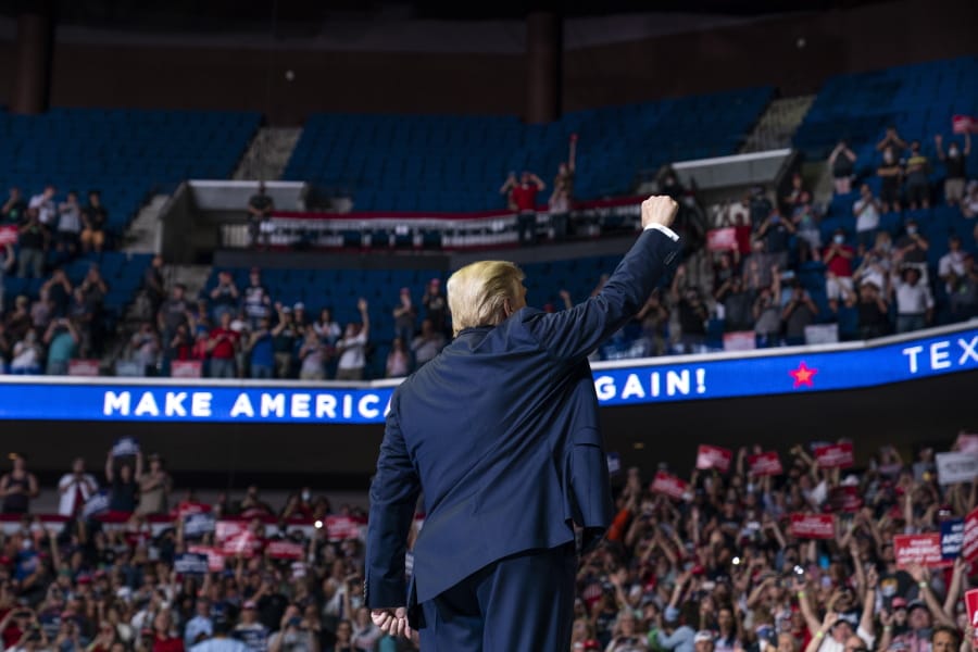 President Donald Trump arrives on stage to speak at a campaign rally at the BOK Center, Saturday, June 20, 2020, in Tulsa, Okla.
