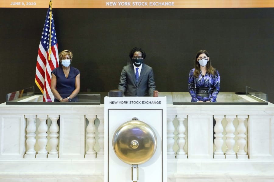 In this photo taken from video provided by the New York Stock Exchange, Frederick Baba, center, managing director Goldman Sachs, accompanied by NYSE President Stacey Cunningham, right, and Intercontinental Exchange Board member Sharon Bowen, rings a single strike of the New York Stock Exchange bell in tribute to the life of George Floyd, initiating eight minutes and forty-six seconds of silence to coincide with the start of Mr. Floyd&#039;s funeral, Tuesday June 9, 2020.