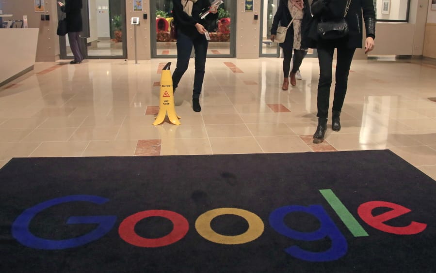 FILE - In this file photo dated Nov. 18, 2019, Google employees walks out of Google France building in Paris. France.  France&#039;Aos highest administrative court on Friday June 19, 2020, has upheld a fine of 50 million euros (dollars 56 million US) against Google for not being &#039;Ausufficiently clear and transparent&#039;Au with users of Android about their data protection options.