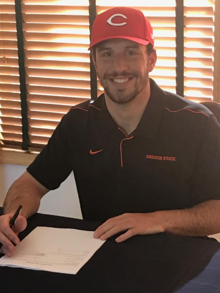 Alex McGarry, a graduate of Columbia River High School and Oregon State, signs a professional baseball contract Wednesday with the Cincinnati Reds