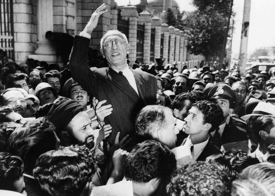 FILE - In this Sept. 27, 1951 file photo, Prime Minister Mohammad Mosaddegh rides on the shoulders of cheering crowds in Tehran&#039;s Majlis Square, outside the parliament building, after reiterating his oil nationalization views to his supporters. The U.S. ambassador to Iran mistakenly told the shah in 1953 that Britain&#039;s newly enthroned Queen Elizabeth II backed a plan to overthrow the country&#039;s elected prime minister and America maintained the fiction even after realizing the error, historians now say.