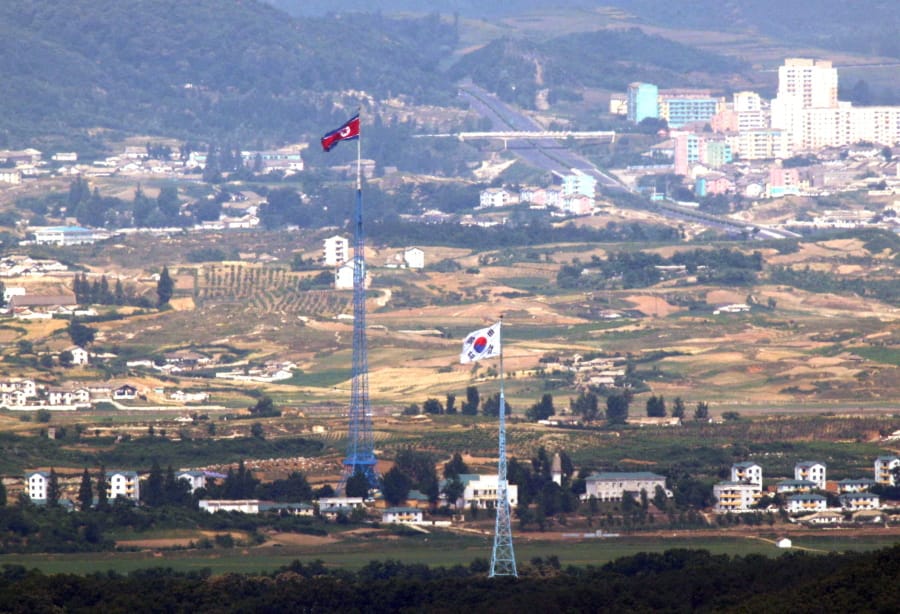 Flags of North Korea, rear, and South Korea, front, flutter in the wind in this photo taken from Paju, South Korea, Friday, June 19, 2020.