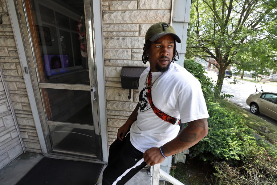 Daylan McLee sits on the porch of his home in Uniontown, Pa., Monday, June 22, 2020. On Sunday McLee helped pull Uniontown Police Officer Jay Hanley from his burning patrol car following a collision. (AP Photo/Gene J.