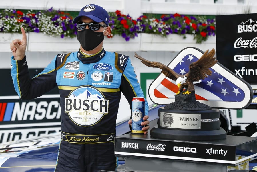 Kevin Harvick celebrates in the winners circle after winning the NASCAR Cup Series auto race at Pocono Raceway, Saturday, June 27, 2020, in Long Pond, Pa.