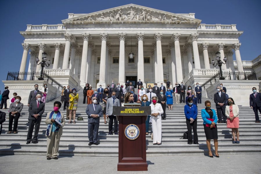 House Speaker Nancy Pelosi of Calif., joined by House Democrats spaced for social distancing, speaks during a news conference on the House East Front Steps on Capitol Hill in Washington, Thursday, June 25, 2020, ahead of the House vote on the George Floyd Justice in Policing Act of 2020.
