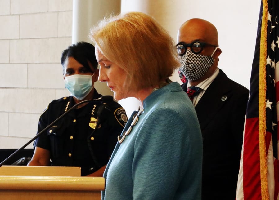 Seattle Mayor Jenny Durkan, center, pauses while speaking, as Chief of Police Carmen Best, left, listens during a news conference Monday, June 22, 2020, in Seattle. Durkan said the city is working with the community to bring the  &quot;Capitol Hill Occupied Protest&quot; zone to an end.