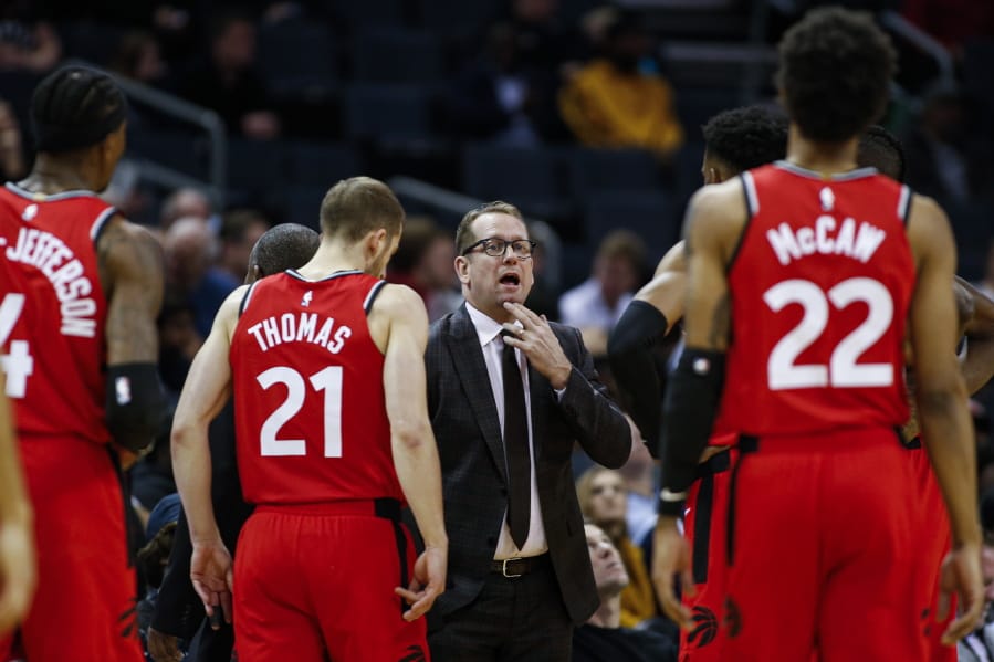 Toronto coach Nick Nurse, center, and the Raptors have an NBA championship to defend, a very long stay at the Disney complex awaiting them and plenty of unanswered questions on how the restart of the season will work.