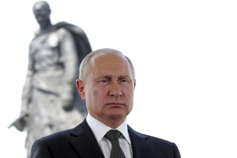 Russian President Vladimir Putin appears in a televised address to the nation in Khoroshevo, the Tver region, with a monument to World War II Red Army soldiers seen in the background, Russia, Tuesday, June 30, 2020. Putin urged voters to cast ballots in a constitutional vote wrapping up Wednesday that could allow him to extend his rule until 2036.