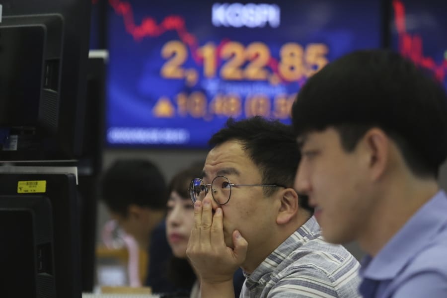 A currency trader watches monitors at the foreign exchange dealing room of the KEB Hana Bank headquarters in Seoul, South Korea, Friday, June 26, 2020. Asian stock markets followed Wall Street higher on Friday after U.S. regulators removed some limits on banks&#039; ability to make investments.