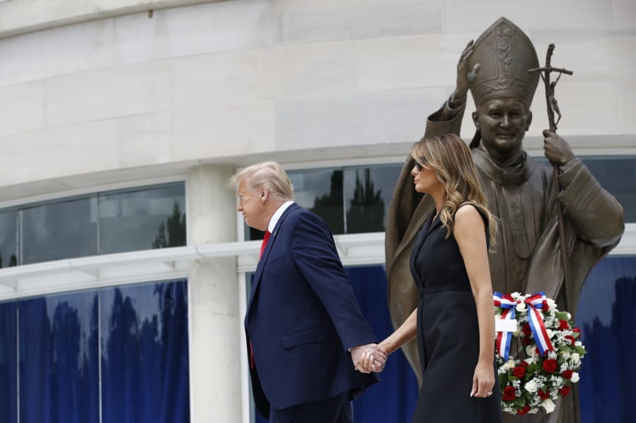 President Donald Trump holds first lady Melania Trump&#039;s hand as they visit Saint John Paul II National Shrine, Tuesday, June 2, 2020, in Washington.