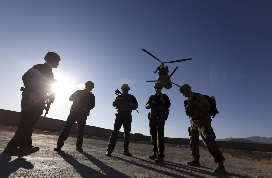 FILE - In this Nov. 30, 2017 file photo, American soldiers wait on the tarmac in Logar province, Afghanistan. Top officials in the White House were aware in early 2019 of classified intelligence indicating Russia was secretly offering bounties to the Taliban for the deaths of Americans, a full year earlier than has been previously reported.