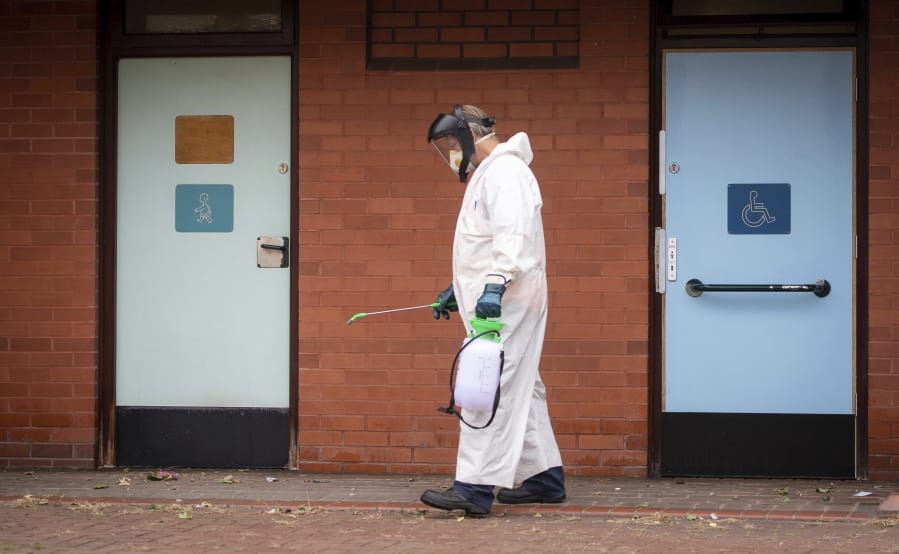 A worker for Leicester City Council disinfects public toilets in Leicester, England, Monday June 29, 2020. The central England city of Leicester is waiting to find out if lockdown restrictions will be extended as a result of a spike in coronavirus infections.