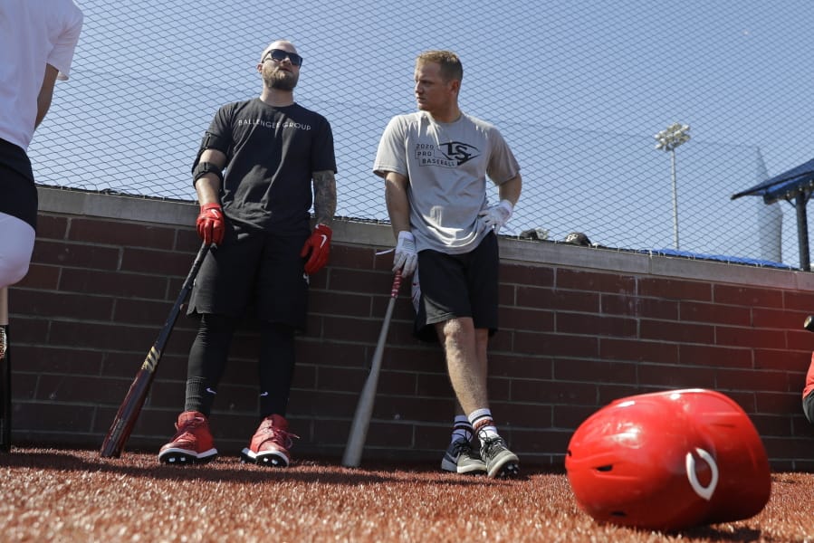 Cincinnati Reds&#039; Tucker Barnhart, left, talks with Josh VanMeter during a workout at Grand Park, Friday, June 12, 2020, in Westfield, Ind. Proceeds from the event will go to Reviving Baseball in the Inner City of Indianapolis.