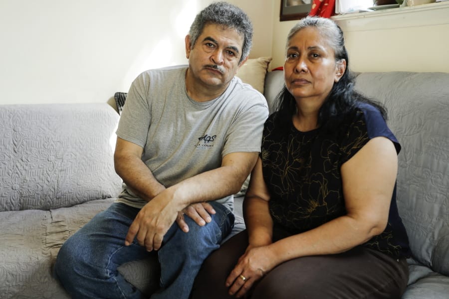 In this Thursday, June 4, 2020, photo, Francisco Flores, left, poses for a portrait with his wife Livia Herrera in New York. When his brother Crescencio Flores died of coronavirus in New York, his parents back in Mexico asked for one thing: that their son be sent home for burial. So far, his efforts have been in vain. &quot;I am trying to do this because my parents, 85 and 87 years old, live there,&quot; Francisco Flores said. &quot;They are rooted in their customs.