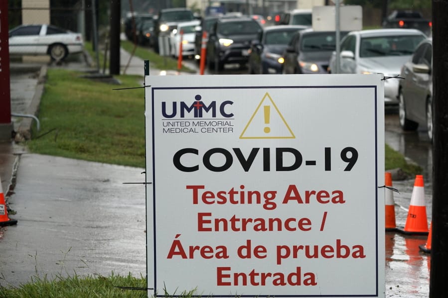 Cars are lined up at a United Memorial Medical Center COVID-19 testing site Wednesday, June 24, 2020, in Houston. Texas Gov. Greg Abbott said Wednesday that the state is facing a &quot;massive outbreak&quot; in the coronavirus pandemic and that some new local restrictions may be needed to protect hospital space for new patients. (AP Photo/David J.