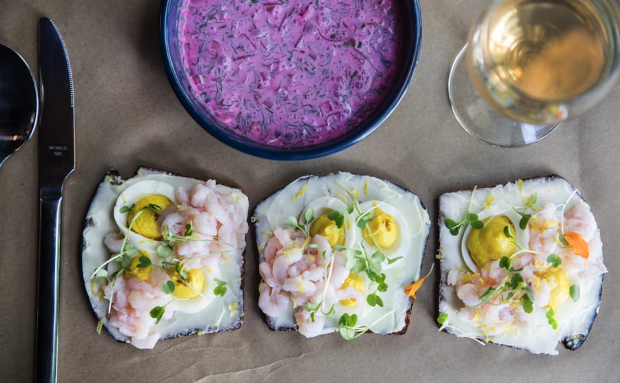 Window light illuminates the cocktail shrimp open-faced sandwiches that are popular along with chlodnik, chilled beet soup with kefir.