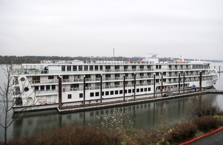 An American Cruise Line ship is pictured on the Columbia River next to the Jantzen Beach Red Lion in Portland on March 22, 2019. American Cruise Lines will dock three mostly empty river cruise ships in Astoria, Ore., beginning Thursday to wait out coronavirus restrictions.