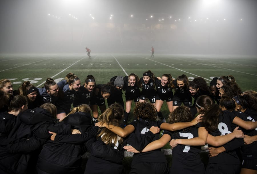 Members of the Union girls team huddle together for a cheer beforeround one of the 4A state soccer playoffs at McKenzie Stadium in Vancouver last season.