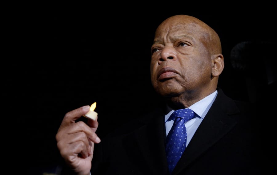 U.S. Rep. John Lewis, D-Ga., holds a candle during an event Jan. 30, 2017, to address President Donald Trump&#039;s executive orders in front of the Supreme Court in Washington, D.C. Lewis died Friday.