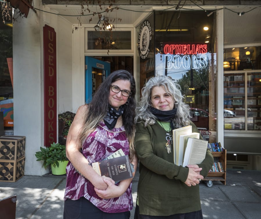 Longtime employee Lisa Maslowe at left and owner Jill Levine outside the Fremont, Washington bookstore, Ophelia&#039;s Books.