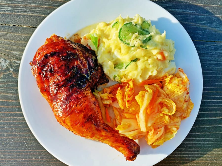 Gochujang-glazed chicken on the grill.&quot; and the other is &quot;Gochujang-glazed grilled chicken with potato salad and kimchi.