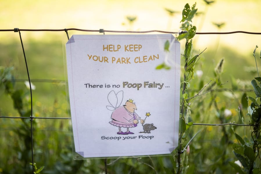 Signs are posted around Ike Dog Park to remind people to pick up after their dogs.