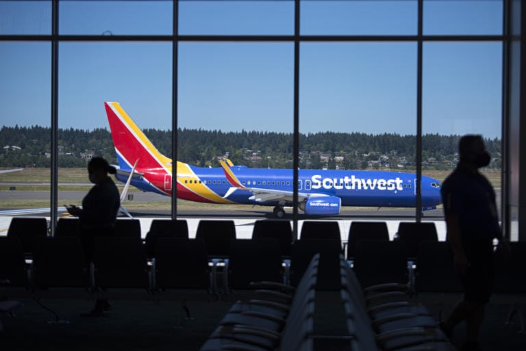 Travelers at gate E10 wait to board a Southwest plane in the new concourse E extension at Portland International Airport on Wednesday afternoon, July 15, 2020. The new section is now the home for Southwest Airlines.