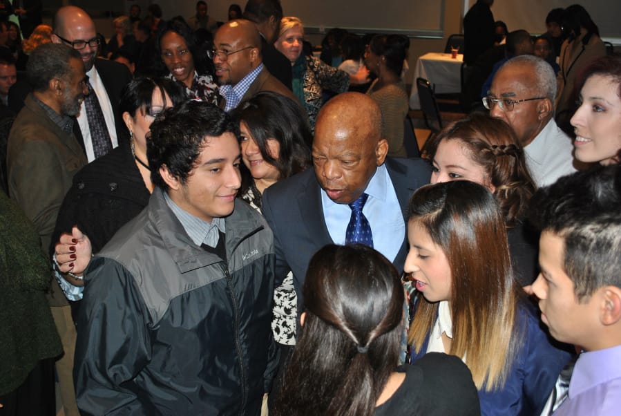 U.S. Rep. John Lewis, the civil rights icon, was a surprise special guest at the 2014 Martin Luther King Jr. Breakfast at Clark College. Here he greets youths with the local League of United Latin American Citizens.