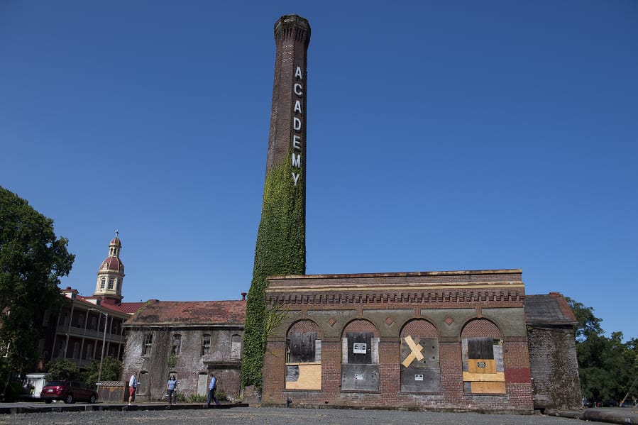 Members of The Historic Trust decided to give up hope of preserving the historic smokestack and boiler building, right, at the Providence Academy, because they couldn't justify the high costs.