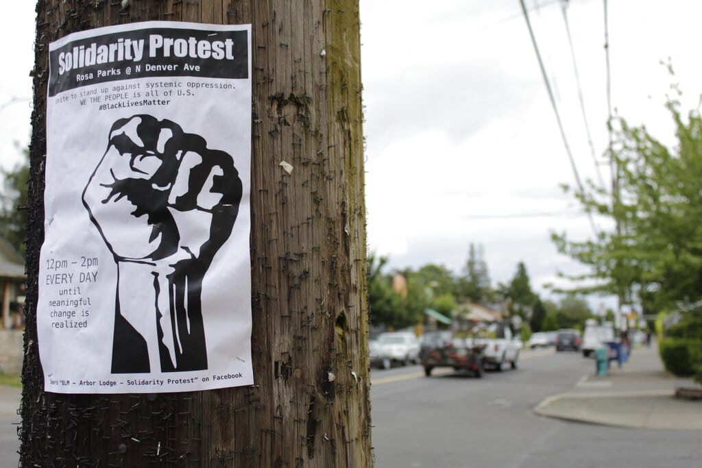 A sign advertising a daily protest in solidarity with Black Lives Matter is affixed to a telephone pole in a historically Black neighborhood in Portland, Ore., on Wednesday, July 1 2020. Thousands of protesters in the liberal and predominantly white city have taken to the streets peacefully every day for more than five weeks to decry police brutality, but recent violence by smaller groups is creating a deep schism in the protest movement and prompting allegations that white protesters are co-opting the moment.
