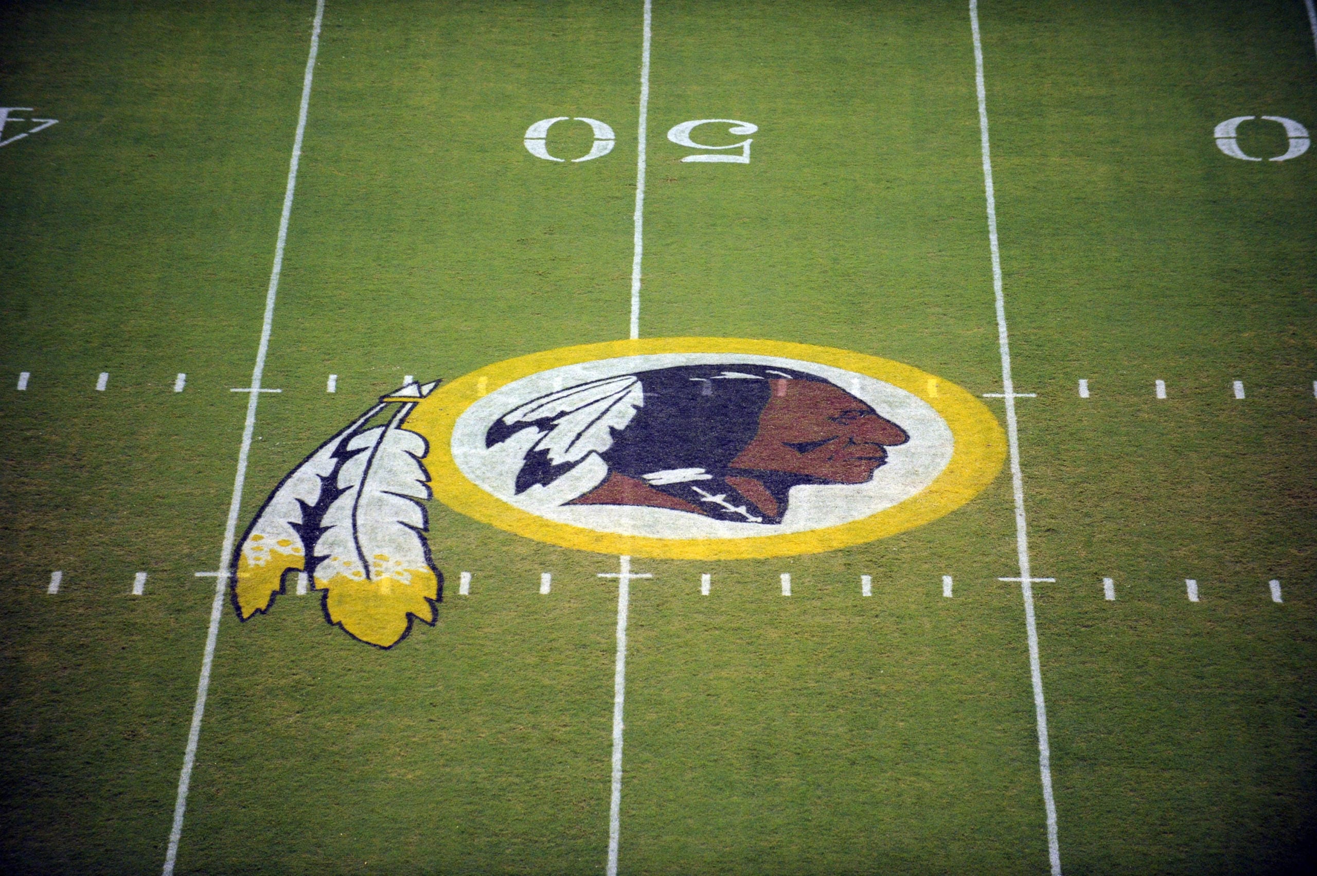 The Washington Redskins logo is shown on the FedEx Field grass in Landover, Md. The Washington Redskins are undergoing what the team calls a “thorough review” of the nickname.