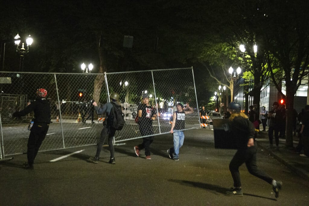 Protesters gathered downtown during a demonstration Thursday, July 16, 2020 n Portland, Ore.   Federal officers deployed tear gas and fired less-lethal rounds into a crowd of protesters late Thursday.