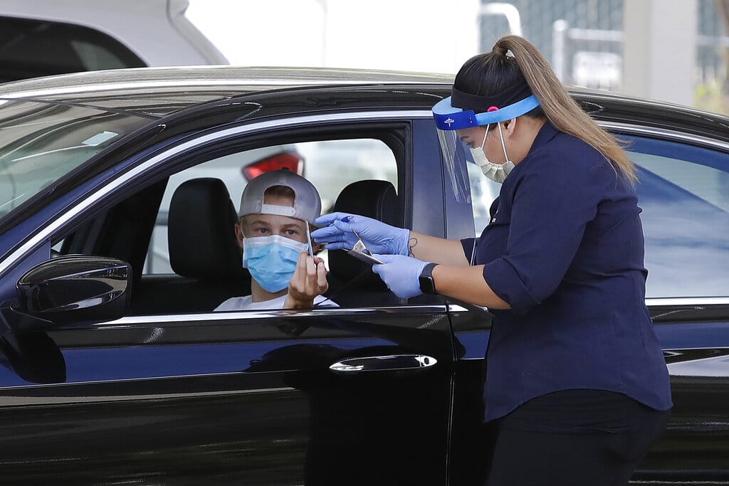 A health care worker takes information from a person at a Covid-19 testing center on Tuesday, July 21, 2020, in Pleasanton, Calif.