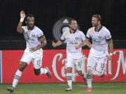 Portland Timbers forward Jeremy Ebobisse (17) celebrates after scoring a goal as midfielder Sebastian Blanco (10) and defender Dario Zuparic (13) come to congratulate him during the second half of an MLS soccer match against the Los Angeles FC, early Friday, July 24, 2020, in Kissimmee, Fla. (AP Photo/Phelan M.