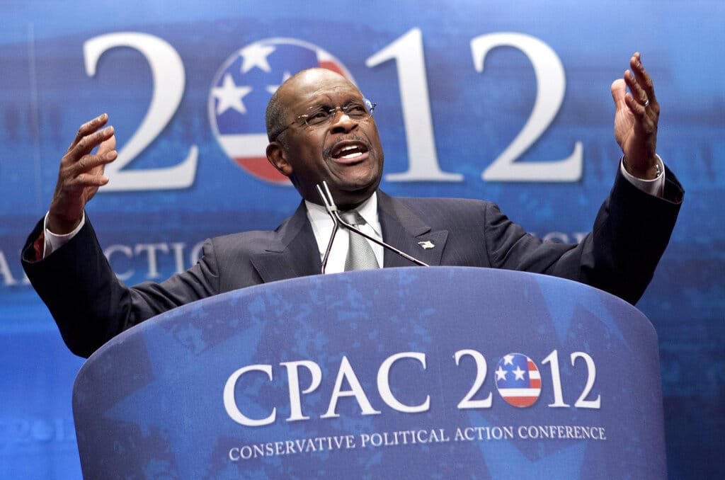 FILE - In this Feb. 9, 2012 file photo, former presidential candidate Herman Cain addresses the Conservative Political Action Conference in Washington.  Cain has died after battling the coronavirus. A post on Cain's Twitter account on Thursday, July 30, 2020 announced the death.   (AP Photo/J.