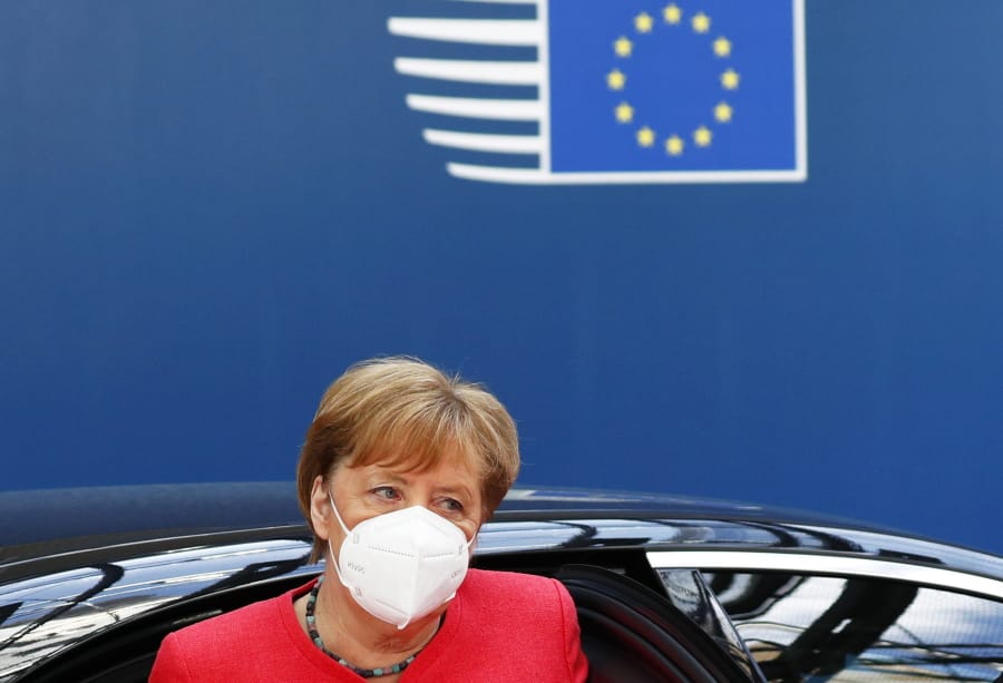 German Chancellor Angela Merkel wears a protective face mask as she arrives for an EU summit in Brussels, Monday, July 20, 2020. Leaders from 27 European Union nations stretch their meeting into a fourth day on Monday to assess an overall budget and recovery package spread over seven years.