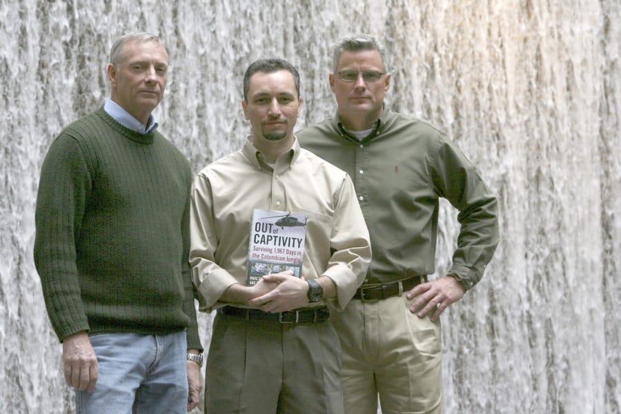Former hostages, from left, Tom Howes, Marc Gonsalves and Keith Stansell are shown in 2009. The American defense contractors were held for years by leftist rebels in Colombia.