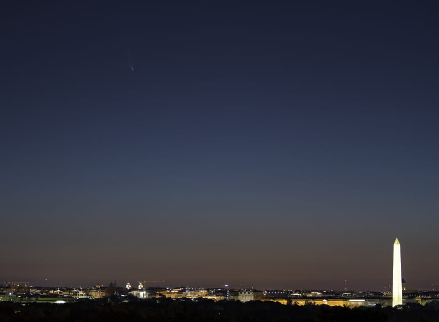 Comet Neowise, upper left, is seen before sunrise over Washington, D.C. last week.