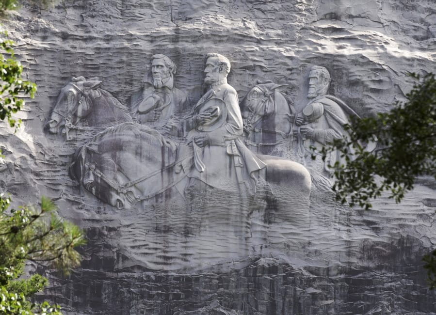 FILE - This June 23, 2015 file photo shows a carving depicting Confederate Civil War figures Stonewall Jackson, Robert E. Lee and Jefferson Davis, in Stone Mountain, Ga. The sculpture is America&#039;s largest Confederate memorial.