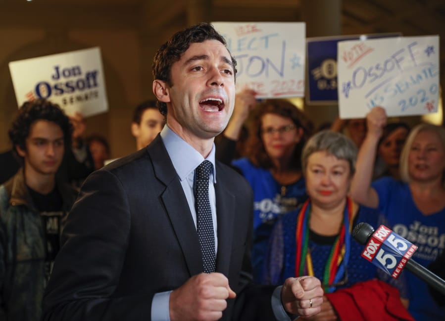 FILE - In this Wednesday, March 4, 2020, file photo, Jon Ossoff speaks to the the media and supporters after he qualified to run in the Senate race against Republican Sen. David Perdue in Atlanta. Two McConnell-allied groups are preparing to spend $22 million to help GOP Sen. David Perdue against Democrat Ossoff in Georgia, where Republican advantages among suburban voters have eroded.