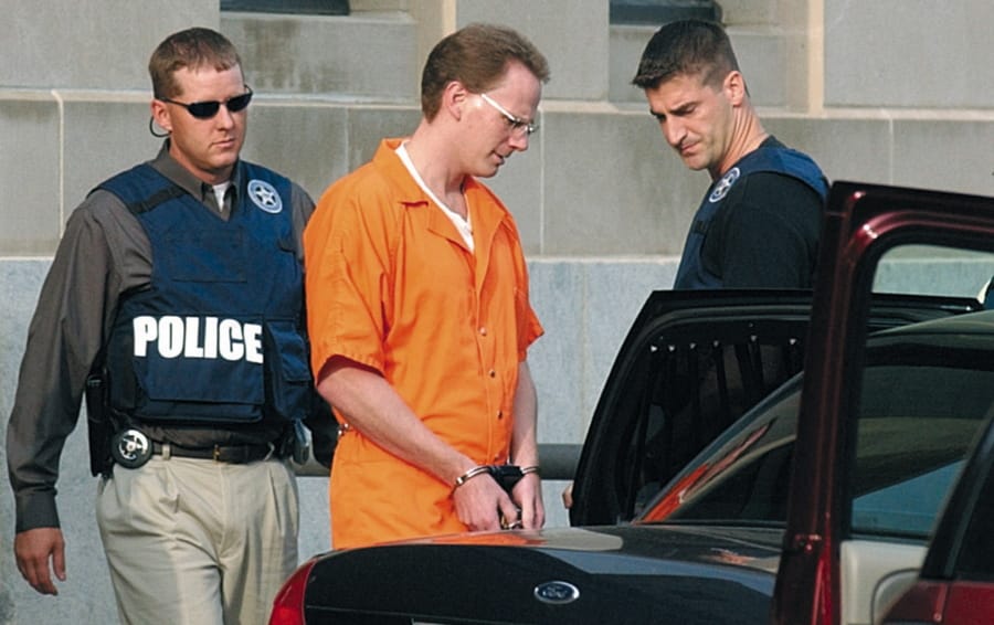 FILE - In this Aug. 18, 2004 file photo, Dustin Honken is led by federal marshals to a waiting car after the second day of jury selection in federal court in Sioux City, Iowa.  A federal judge has denied the Iowa drug kingpin&#039;s requests to delay his execution, which is scheduled for Friday, July 17, 2020. U.S. District Judge Leonard Strand wrote Tuesday, July 14 that he would not intervene to delay Honken&#039;s execution date due to the coronavirus pandemic. He said the Bureau of Prisons was in the best position to weigh the health risks against the benefits of carrying out the execution.