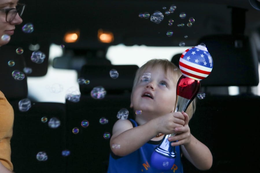 Brittani Scott watches her son, Cooper Scott, 2, play with bubbles while waiting to see a display of fireworks at Nathan Benderson Park, on Friday, July 3, 2020, in Sarasota, Florida.