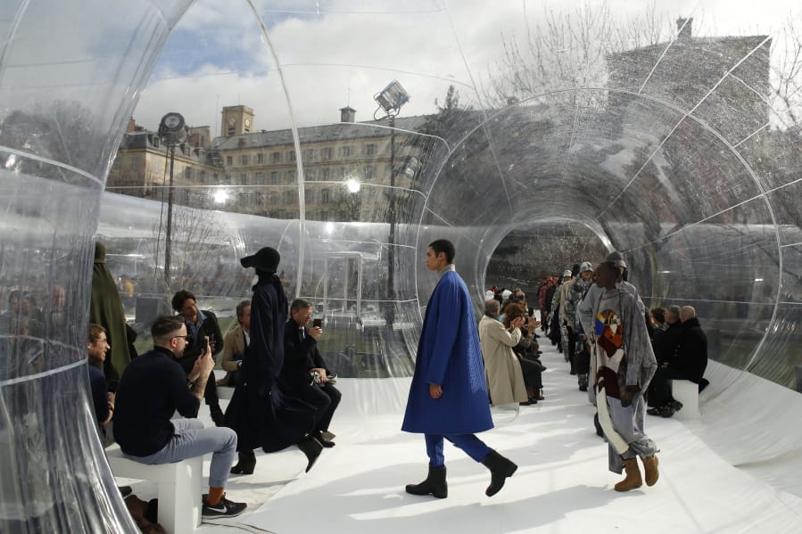 FILE - In this Feb. 26, 2020 file photo, models wear creations for the Kenzo fashion collection during Women&#039;s fashion week Fall/Winter 2020/21 presented in Paris. The coronavirus pandemic has instilled extra unpredictability into the already fickle Paris Fashion Week. After first canceling the July shows for menswear and Haute Couture, the French fashion federation has now organized an unprecedented schedule of digital-only events instead.
