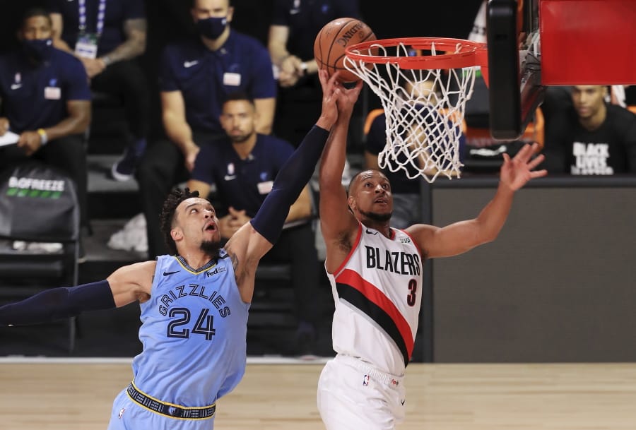 Portland Trail Blazers&#039; CJ McCollum (3)  of the shoots the ball past Memphis Grizzlies&#039; Dillon Brooks  during the first half of an NBA basketball game Friday, July 31, 2020, in Lake Buena Vista, Fla.