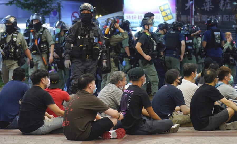 Police detain protesters against the new security law during a march marking the anniversary of the Hong Kong handover from Britain to China, Wednesday, July. 1, 2020, in Hong Kong. Hong Kong marked the 23rd anniversary of its handover to China in 1997 just one day after China enacted a national security law that cracks down on protests in the territory.