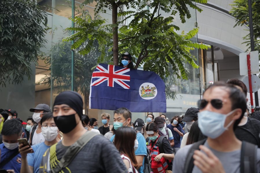 A man displays the Hong Kong colonial flag on the anniversary of Hong Kong&#039;s handover to China from Britain in Hong Kong, Wednesday, July. 1, 2020. Hong Kong marked the 23rd anniversary of its handover to China in 1997, and just one day after China enacted a national security law that cracks down on protests in the territory.