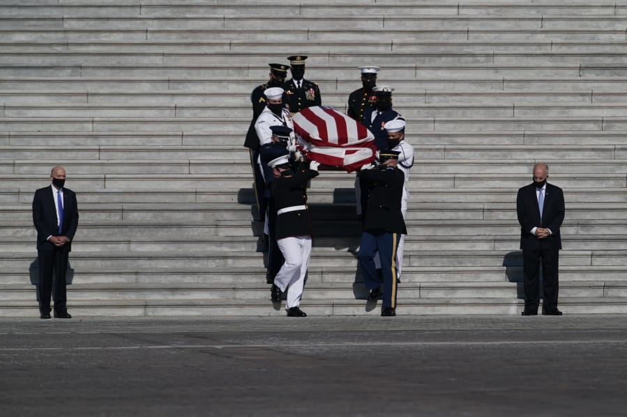 The flag-draped casket of the late Rep. John Lewis, D-Ga., is carried by a joint services military honor guard from Capitol Hill, Wednesday, July 29, 2020, in Washington.
