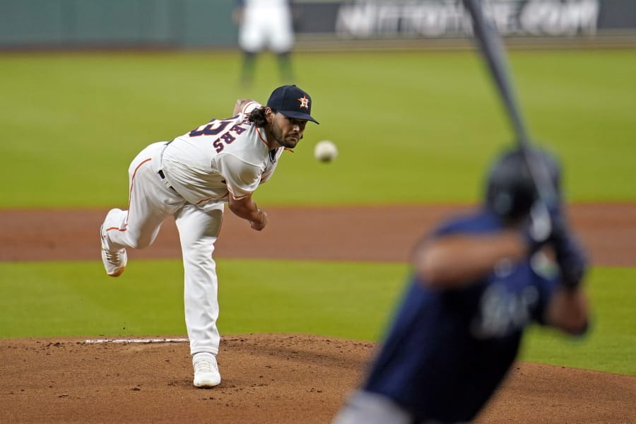 Houston Astros starting pitcher Lance McCullers Jr., left, throws to Seattle Mariners&#039; Evan White during the first inning of a baseball game Saturday, July 25, 2020, in Houston. (AP Photo/David J.