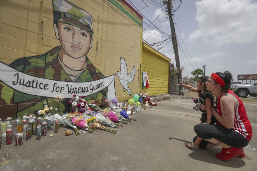 Dawn Gomez holds her 3-year-old granddaughter, Saryia Greer, who waves at Vanessa Guillen&#039;s mural painted by Alejandro &quot;Donkeeboy&quot; Roman Jr. on the side of Taqueria Del Sol, Thursday, July 2, 2020, in Houston. Army investigators believe Guillen, a Texas soldier missing since April, was killed by another soldier on the Texas base where they served, the attorney for the missing soldier&#039;s family said Thursday.