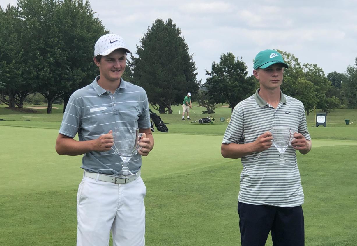 Mountain View's Graham Moody, left, poses with his championship trophy after winning the Oregon Junior Amateur on Friday at the OGA Golf Course in Woodburn. He beat Nicholas Watts of Springfield, right, 3 and 2.